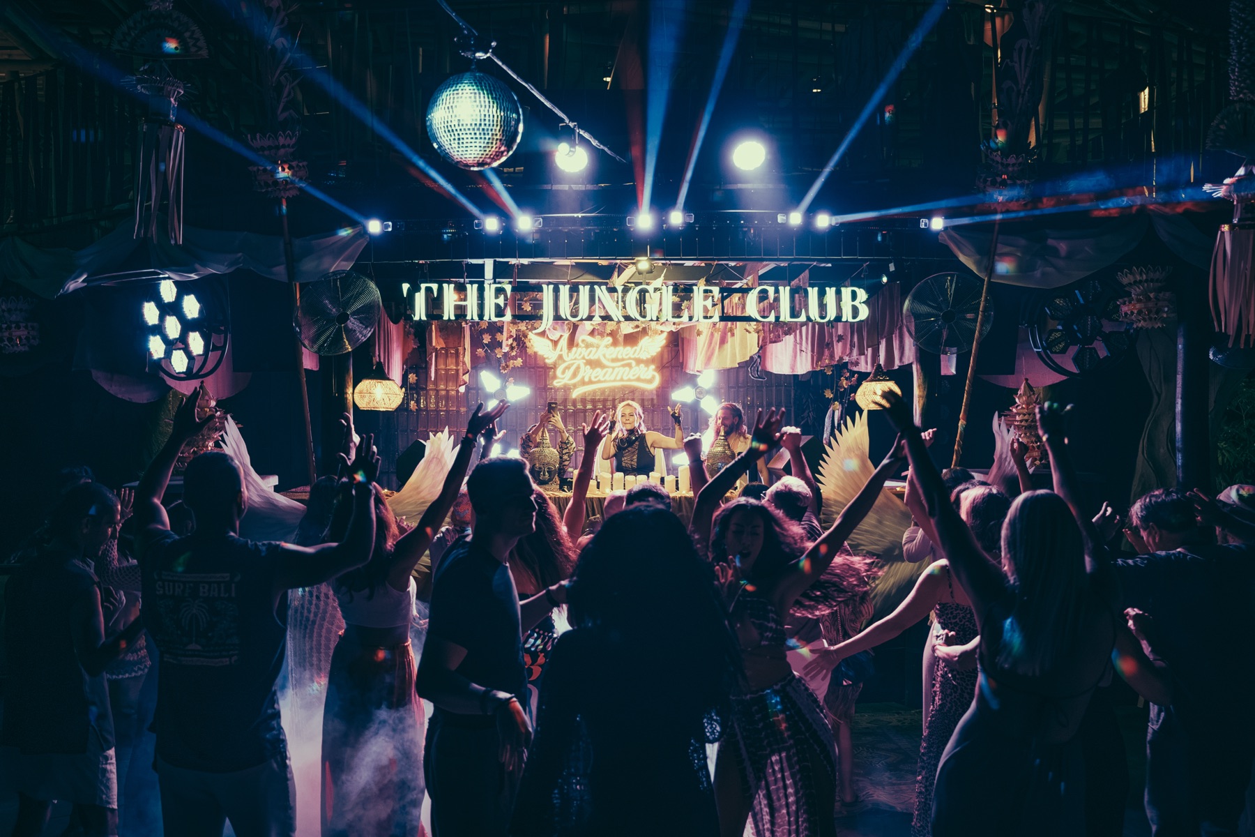 A packed dance floor with hands raised at Awakened Dreamers, The Jungle Club, Bali